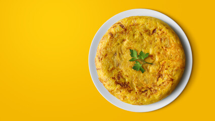 Potato and onion omelette in a plate on a yellow background