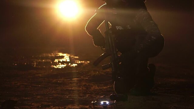Soldiers in a military uniform with a weapon in his hands and a laser sight