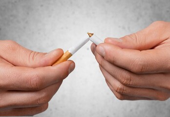 Stop smoking concept. The woman hands broken cigarette