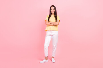 Full length photo of cute adorable lady wear yellow t-shirt arms folded smiling isolated pink color background