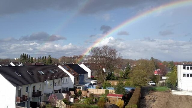 Double rainbow in residential neighborhood with small houses