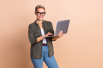 Photo of gorgeous recruiter girl hold use wireless netbook networking isolated on beige color background