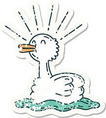 worn old sticker of a tattoo style swimming duck