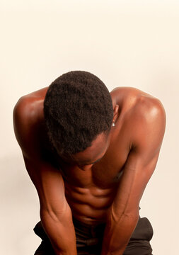 Strong black man with naked torso in studio