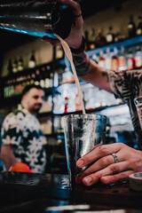man hand bartender making cocktail in glass on the bar counter