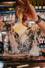 man hand bartender making cocktail in glass on the bar counter