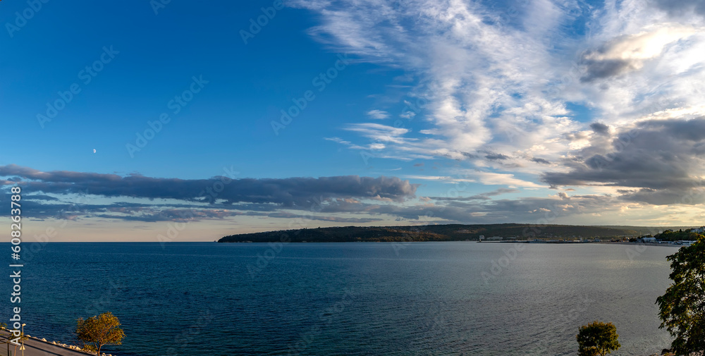 Wall mural Panoramic view at sea bay and cloudy sunset sky.