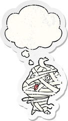 cartoon halloween mummy with thought bubble as a distressed worn sticker