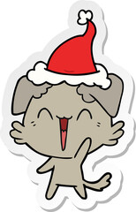 happy little dog hand drawn sticker cartoon of a wearing santa hat