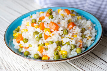 Delicious vegetable rice pilaf with green peas, carrots and sweet corn (Turkish name; sebzeli pilav)