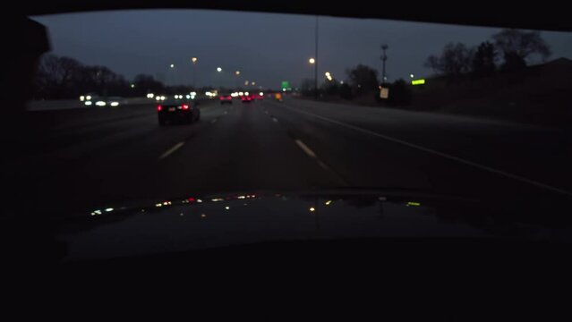 Background Plate Of Night Time POV Point Of View Of Traffic And City Lights From Car Hood And Driver Perspective Moving Towards Downtown District Out Of Focus