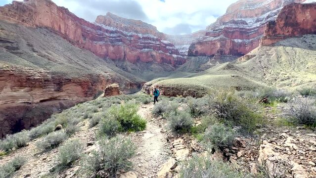Hiker Climbs Hill And Pauses For Photo In Grand Canyon Along the Tonto Trail