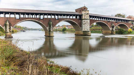 Fototapeta na wymiar Covered bridge over the Ticino River in Pavia, Italy