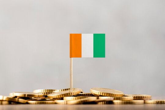 The Flag of Côte d'Ivoire with Coins. - Powered by Adobe