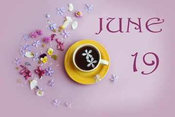 Calendar for June 19: the name of the month June in English, the numbers 19, a yellow cup with tea, scattered flowers nearby on a pastel background