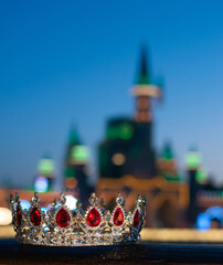 Royal luxury crown with red gemstones on castle background