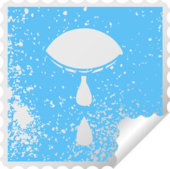 distressed square peeling sticker symbol of a crying eye