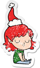 hand drawn distressed sticker cartoon of a elf girl wearing santa hat