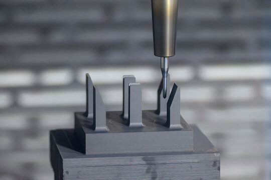 The CNC milling machine finish cutting the graphite electrode parts with solid ball end mill.