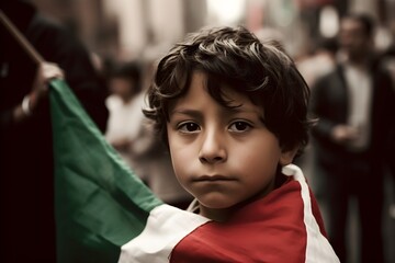 Portrait of a little boy holding the flag of Mexico