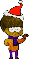 nervous hand drawn textured cartoon of a boy wearing santa hat