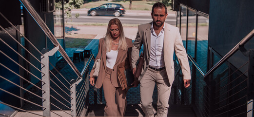 Obraz na płótnie Canvas Modern business couple after a long day's work, walking together towards the comfort of their home, embodying the perfect blend of professional success and personal contentment.