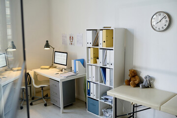 Modern office of doctor pediatrician with workplace and closet with folders