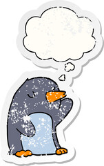 cartoon penguin with thought bubble as a distressed worn sticker