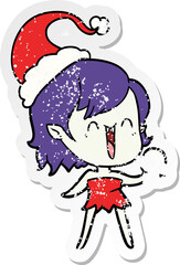cute hand drawn distressed sticker cartoon of a happy vampire girl wearing santa hat