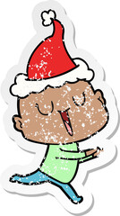 happy hand drawn distressed sticker cartoon of a bald man wearing santa hat
