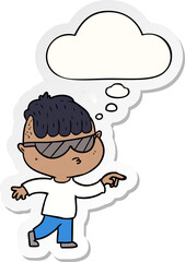 cartoon boy wearing sunglasses pointing with thought bubble as a printed sticker