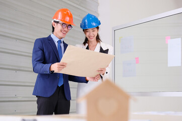 Engineer looks at drawings to design a house structure. Engineer concept.