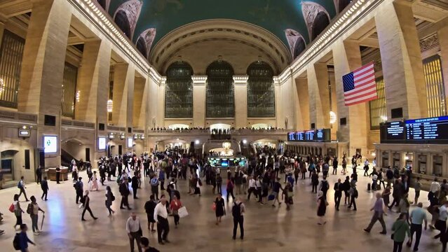 Timelapse of the historic Grand Central Station with crowd of commuters rushing towards the platforms.