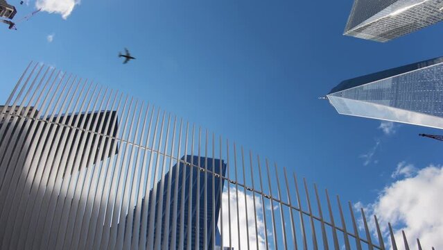 Plane flying above One World Trade Center skyscraper and Oculus in New York. One World Trade Center is main building of the rebuilt World Trade Center complex after the 9/11 attack in Lower Manhattan
