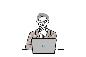 A senior executive sits at his laptop, thinking.