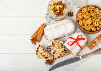 Christmas stollen on wooden background. Traditional Christmas festive pastry dessert. Stollen for Christmas.Christmas fruit cake, pudding on a white plate.Traditional German Christmas pastry.