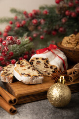 Christmas stollen on wooden background. Traditional Christmas festive pastry dessert. Stollen for Christmas.Christmas fruit cake, pudding on a white plate.Traditional German Christmas pastry.