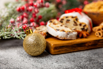 Christmas stollen on wooden background. Traditional Christmas festive pastry dessert. Stollen for Christmas.Christmas fruit cake, pudding on a white plate.Traditional German Christmas pastry.