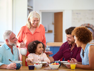 Obraz na płótnie Canvas Multi-Generation Family At Home Enjoying Breakfast Together