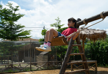 asian girl playing swing