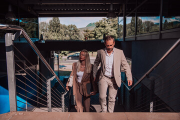 Modern business couple after a long day's work, walking together towards the comfort of their home, embodying the perfect blend of professional success and personal contentment.