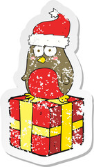 retro distressed sticker of a cartoon robin on present