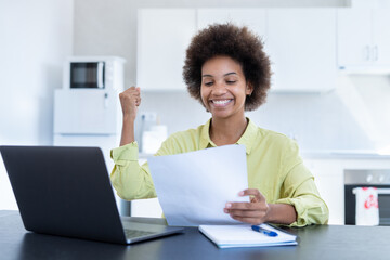 Happy smiling remote working young black female receive postal letter from company office about project report approval. Glad millennial afro american employee reading good news from paper document.