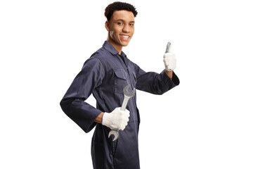 African american car mechanic holding a wrench and gesturing thumbs up