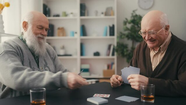 Elderly men playing card game, senior leisure, best friends hanging out, relax