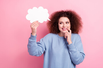 Photo of tricky cunning girl wear blue shirt holding speaking cloud empty space isolated pink color background