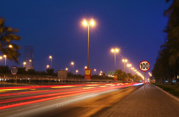 Fototapeta na wymiar Urban street in the city at night with vivid color car light trails