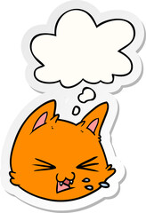 spitting cartoon cat face with thought bubble as a printed sticker