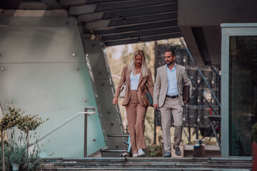 Fototapeta na wymiar Modern business couple after a long day's work, walking together towards the comfort of their home, embodying the perfect blend of professional success and personal contentment.