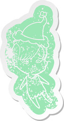 quirky cartoon distressed sticker of a surprised girl wearing santa hat